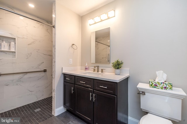 full bathroom featuring a marble finish shower, toilet, and vanity