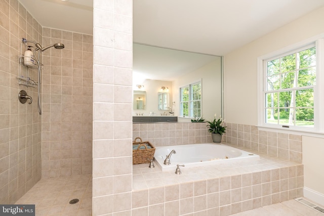 full bathroom featuring tiled shower, a whirlpool tub, and tile patterned floors