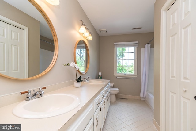 full bathroom featuring tile patterned flooring, toilet, double vanity, and baseboards