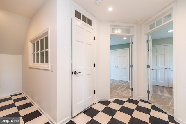 hall with tile patterned floors, baseboards, recessed lighting, and carpet flooring