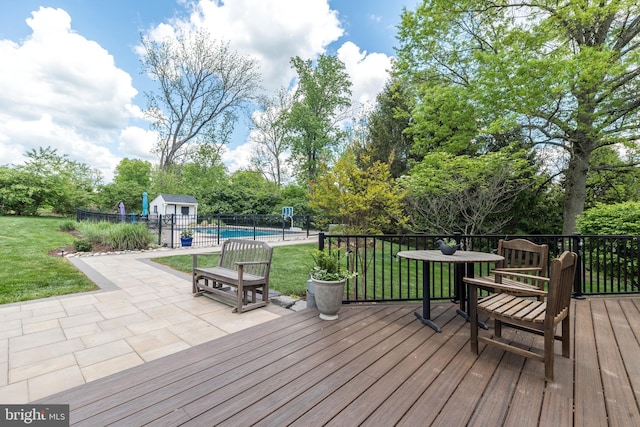 deck with an outbuilding and a patio area