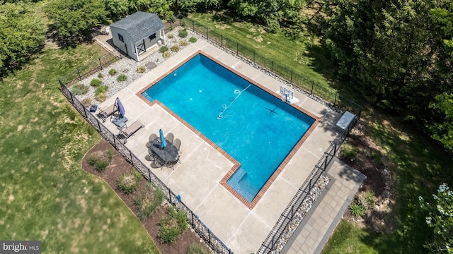 view of swimming pool with an outbuilding, a patio area, and an exterior structure