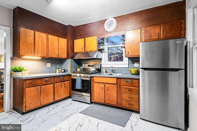 kitchen with stainless steel appliances, tasteful backsplash, marble finish floor, and a sink
