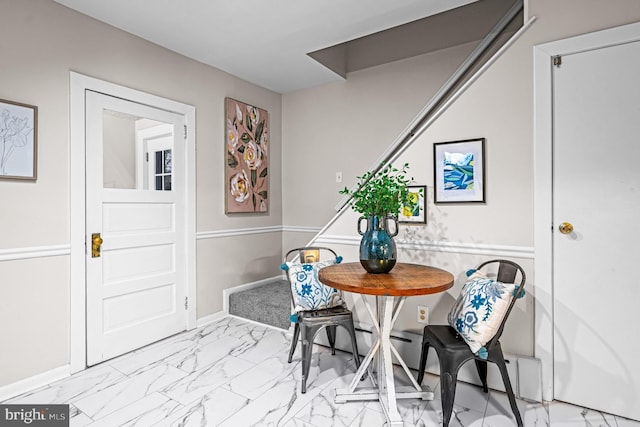 dining space featuring marble finish floor