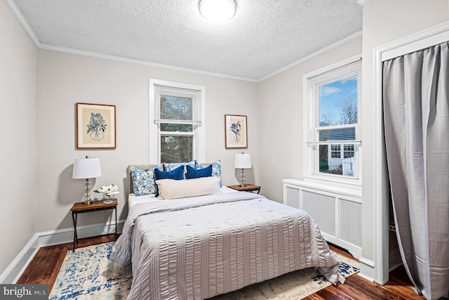 bedroom featuring crown molding, multiple windows, and wood finished floors