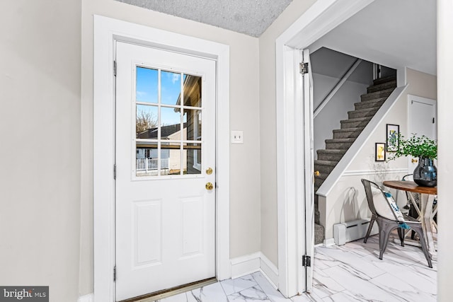 entryway with baseboards, stairway, marble finish floor, and a textured ceiling