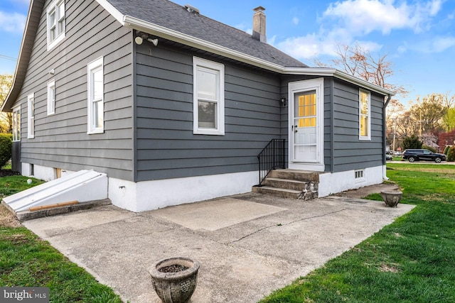 exterior space with a yard and a chimney