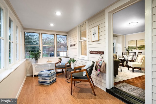 sunroom / solarium featuring plenty of natural light, baseboards, and wood finished floors