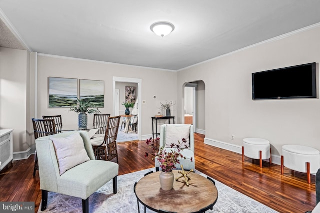 living room featuring crown molding, arched walkways, and hardwood / wood-style flooring
