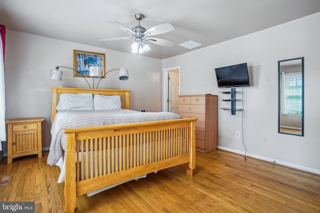 bedroom with wood finished floors, a ceiling fan, and baseboards