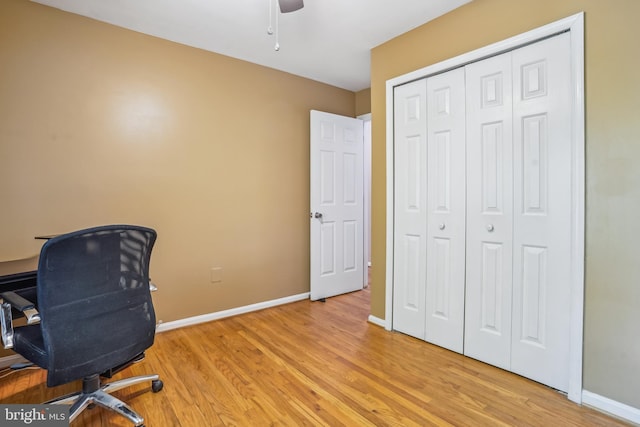 office with a ceiling fan, light wood-style flooring, and baseboards
