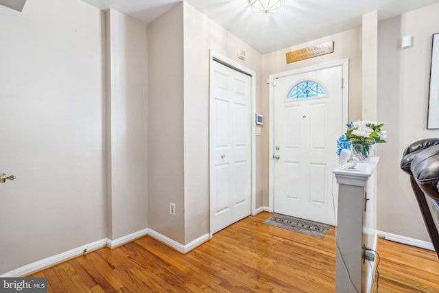 foyer with light wood-type flooring and baseboards