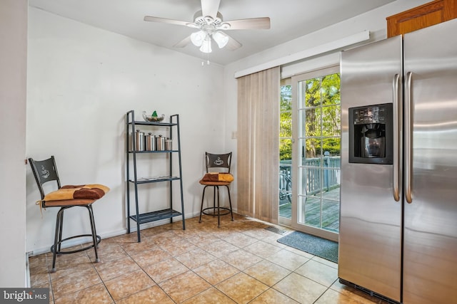 interior space featuring light tile patterned floors and a ceiling fan