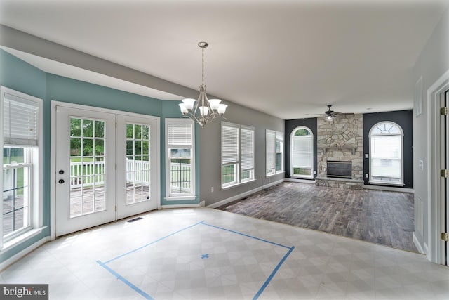 33 General Early Dr, Harpers Ferry, WV 25425 - unfurnished living room with a stone fireplace, ceiling fan, a chandelier, and tile patterned floors