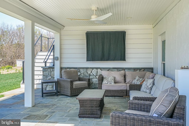 view of patio featuring stairs, a ceiling fan, and an outdoor hangout area
