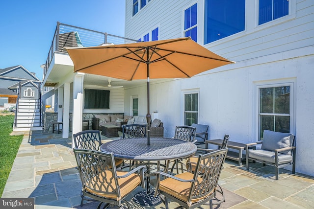 view of patio with outdoor lounge area, outdoor dining space, and stairs
