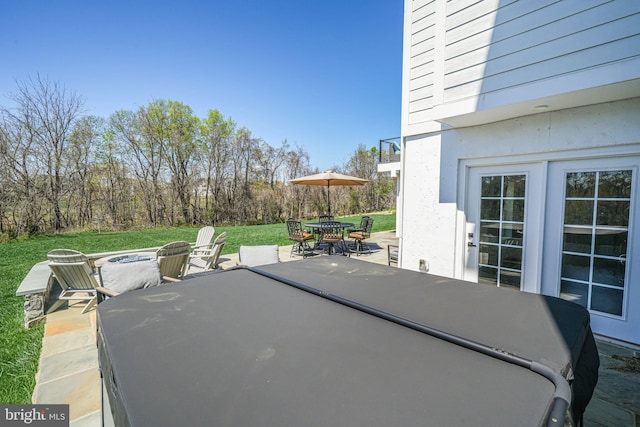 view of patio with outdoor dining area and an outdoor fire pit