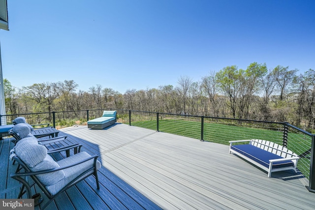 wooden terrace featuring a yard