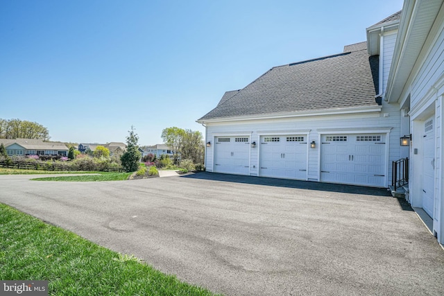 garage with aphalt driveway