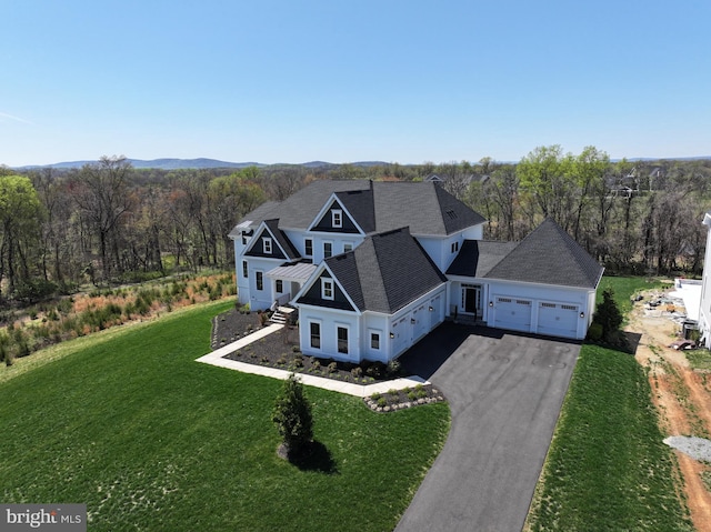 birds eye view of property featuring a view of trees