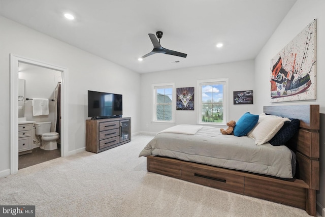 carpeted bedroom with baseboards, recessed lighting, and connected bathroom