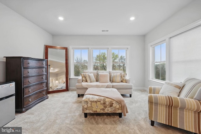 sitting room with light carpet, baseboards, visible vents, and recessed lighting