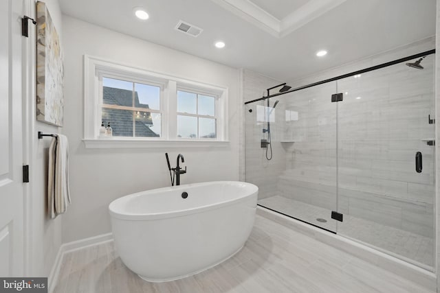 bathroom with visible vents, baseboards, a freestanding tub, a shower stall, and recessed lighting