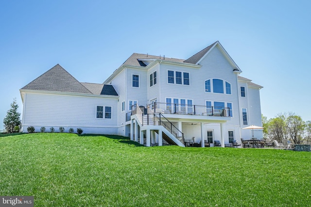 back of property featuring a yard, stairway, and a patio area