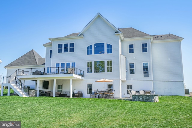 back of house featuring a patio, stairway, and a yard
