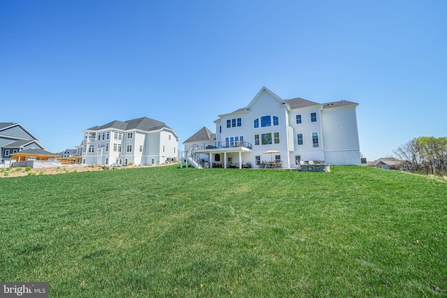 back of property with a lawn and stairs