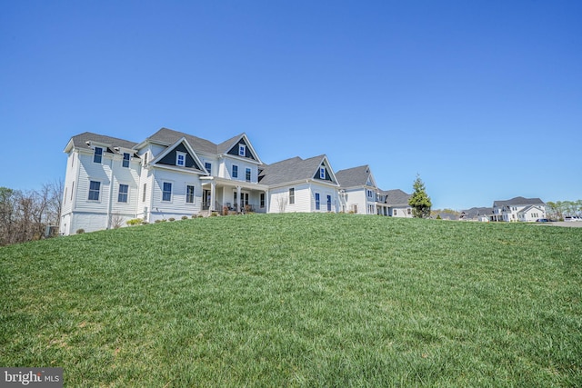 view of front of home with a residential view and a front lawn