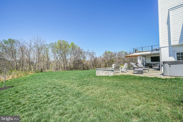 view of yard featuring a patio area and a hot tub