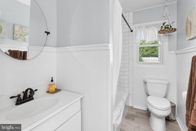 1 Pheasant Ln, Hamilton, NJ 08690 - bathroom featuring a wainscoted wall, vanity, wood finished floors, toilet, and shower / bath combo with shower curtain