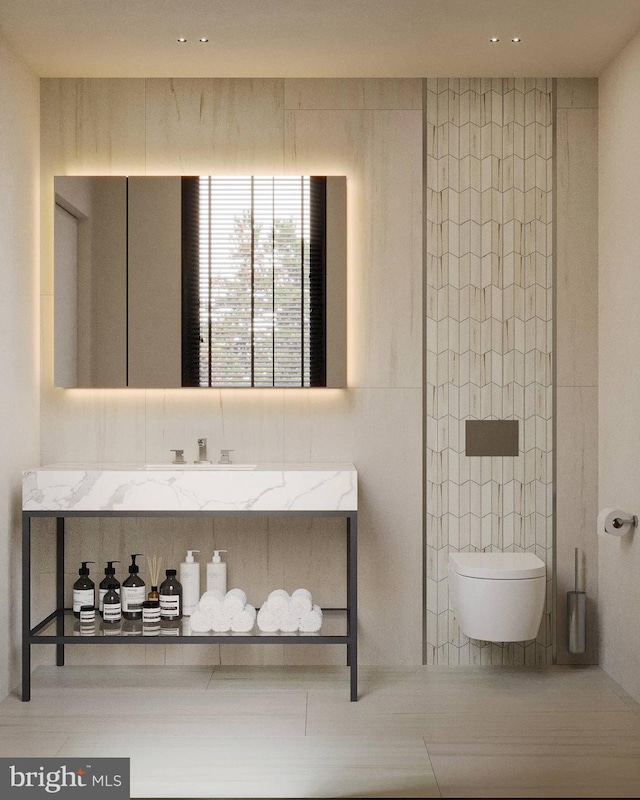 bathroom featuring tile walls, toilet, and vanity
