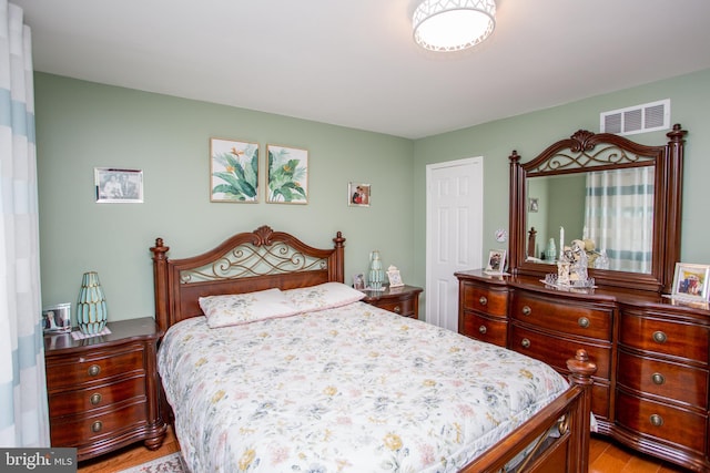 bedroom featuring light wood-style flooring and visible vents