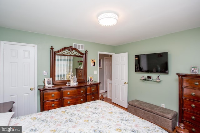 bedroom with wood finished floors and visible vents