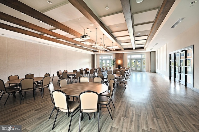 dining area featuring visible vents, a chandelier, beam ceiling, wood finished floors, and french doors
