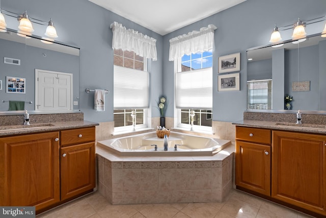bathroom featuring a sink, two vanities, a shower stall, and visible vents