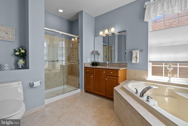 full bath featuring a bath, vanity, tile patterned flooring, and a shower stall