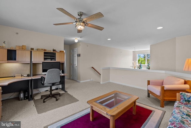 office featuring light colored carpet, baseboards, ceiling fan with notable chandelier, and recessed lighting