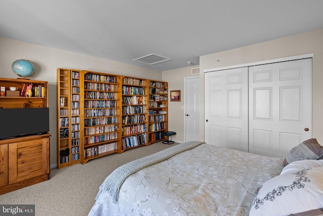 carpeted bedroom with attic access, a closet, baseboards, and visible vents