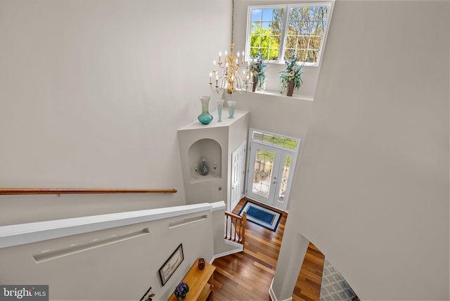 foyer with a chandelier and wood finished floors