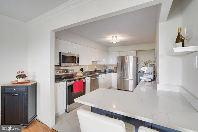 203 Yoakum Pkwy Unit 1807, Alexandria, VA 22304 - kitchen featuring stainless steel appliances, a peninsula, backsplash, a sink, and white cabinets