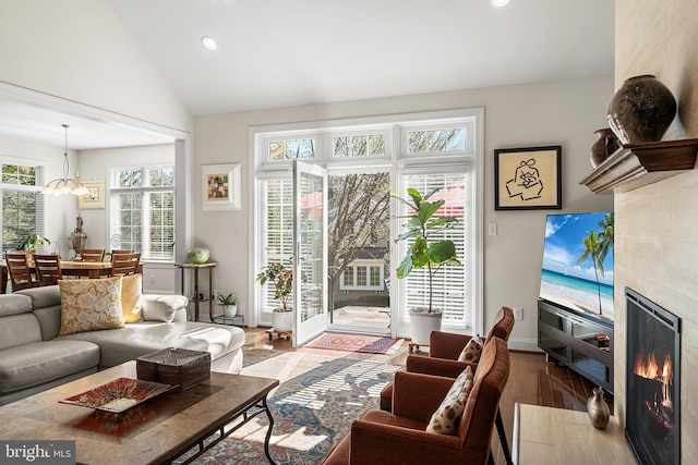 1430 County Line Rd, Bryn Mawr, PA 19010 - living room featuring a notable chandelier, recessed lighting, lofted ceiling, a tile fireplace, and wood finished floors