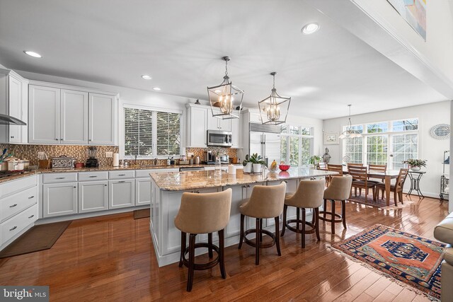 1430 County Line Rd, Bryn Mawr, PA 19010 - kitchen featuring tasteful backsplash, appliances with stainless steel finishes, a chandelier, white cabinetry, and a kitchen island
