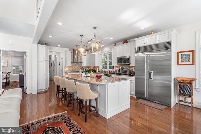 1430 County Line Rd, Bryn Mawr, PA 19010 - kitchen featuring dark wood finished floors, wall chimney exhaust hood, decorative backsplash, and appliances with stainless steel finishes