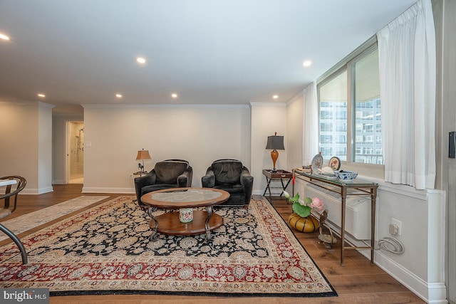 sitting room featuring recessed lighting, baseboards, crown molding, and wood finished floors