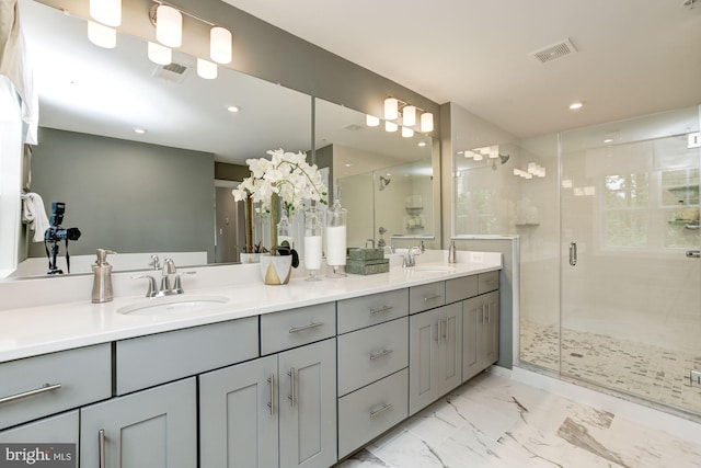 full bathroom with a shower stall, visible vents, marble finish floor, and a sink