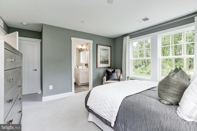 bedroom featuring visible vents, baseboards, and light carpet