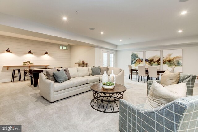 living area featuring light carpet and recessed lighting